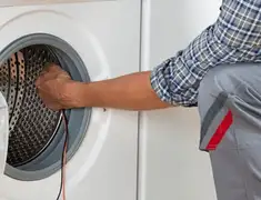 Dryer repair technician diagnosing and servicing a clothes dryer in Madison, WI
