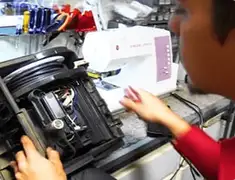 Vacuum repair technician servicing internal components on a workbench in Madison, WI