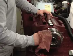 Vacuum repair technician cleaning and servicing a vacuum motor in Madison, WI