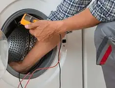 Washing machine repair technician testing a front-load washer with diagnostic tools in Madison, WI
